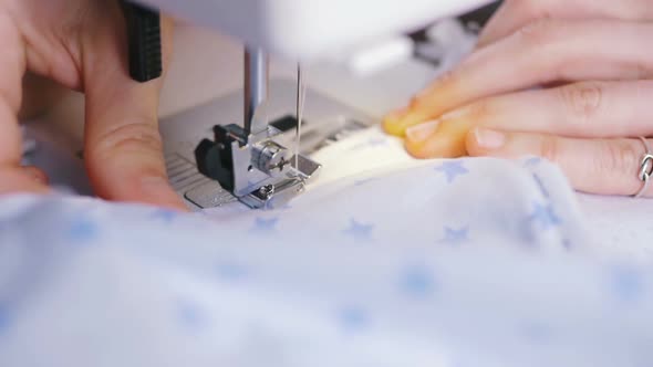 Female Hands Working on Sewing Machine Close Up