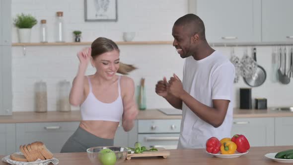 Sporty African Man and Woman Dancing in Kitchen