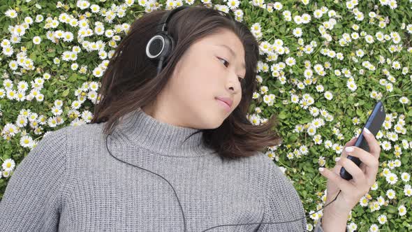 Beautiful young woman relaxing at park in spring - Young asian chinese woman