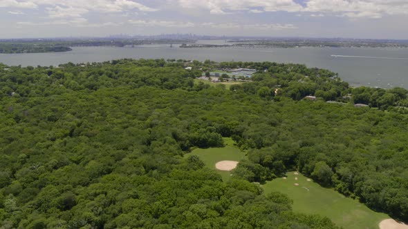 Aerial View of a Long Island Village by the Water and NYC Skyline Seen from Afar