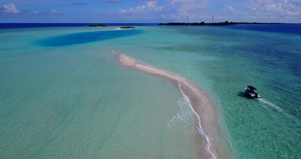 Beautiful fly over island view of a paradise sunny white sand beach and aqua blue water background i
