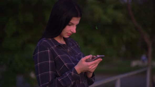 Attractive Woman with Smartphone on Street Walking and Texting on Phone