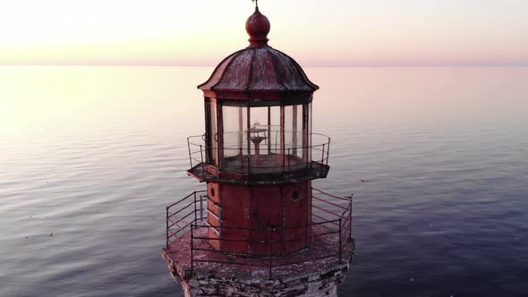 Aerial shot of lighthouse, camera fly close around top of tower