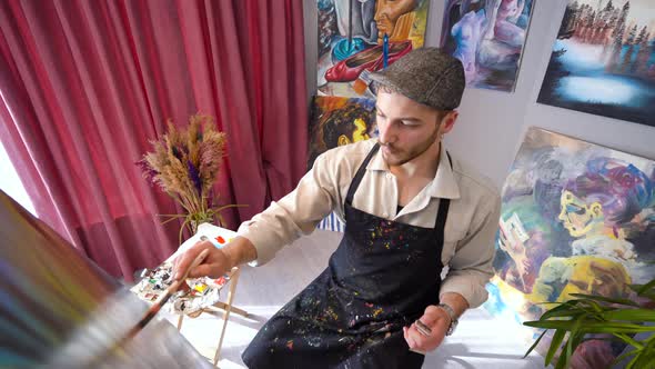 The painter paints oil paintings.