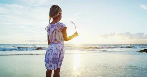 Young Girl with American Flag on Beach