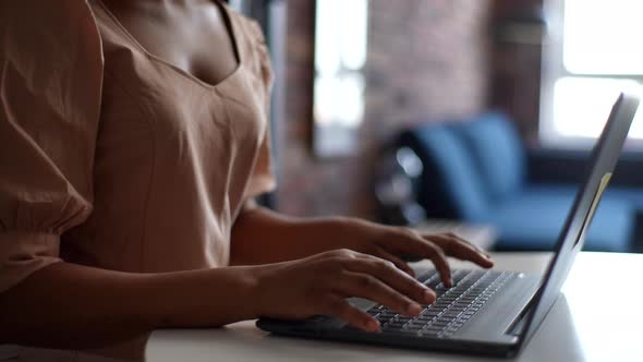 Closeup Cropped Shot of Unrecognizable African Female Student Typing on Notebook Keyboard Studying