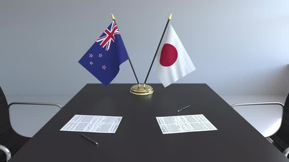 Flags of New Zealand and Japan and Papers