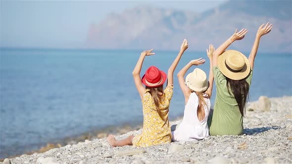 Adorable Little Girls and Young Mother on Tropical White Beach