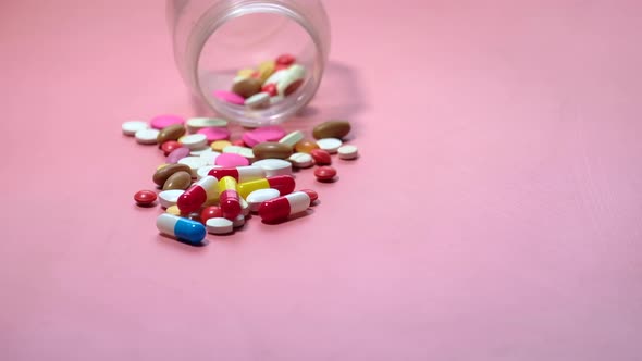 Close Up of Colorful Pills Spilling From Container 