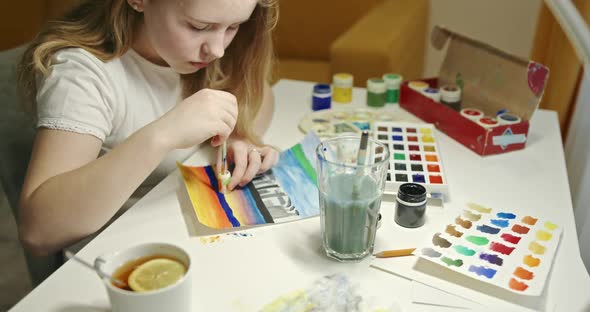 Girl Painting with Watercolor at Home