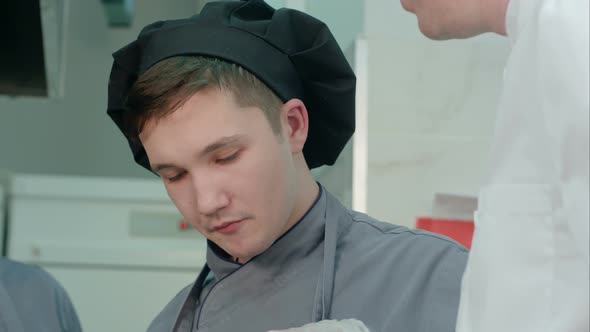 Young Cook Trainee Tasting Seafood Dish