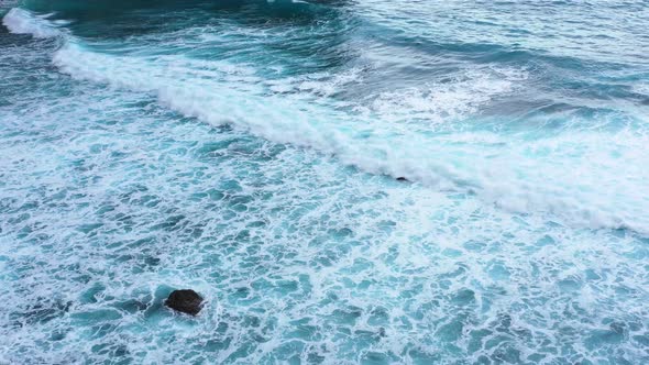 Indonesia. Waves and azure water as a background. View from drone at the ocean surface. 