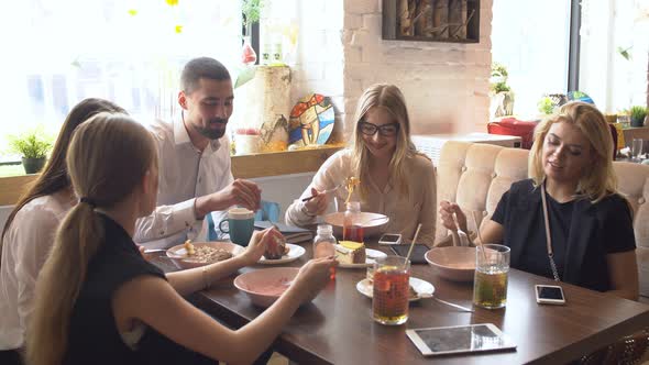 Business Colleagues Eating Meal Together While Discussing of Work.