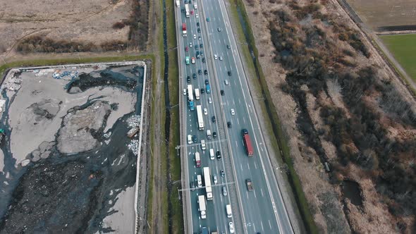 Highway with Cars Near Construction Site with Trench Aerial