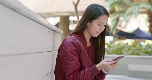 Woman use of mobile phone in city