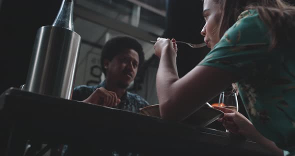 Young couple dining and talking at the table