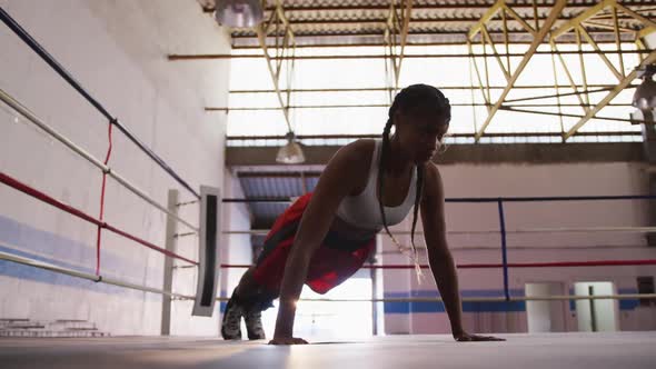 Mixed race woman working out in boxing gym