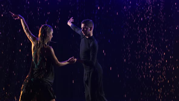 Passionate Bachata Dance Among the Raindrops Performed By a Young Sensual Couple of Dancers