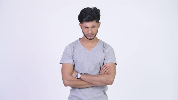 Young Angry Bearded Indian Man with Arms Crossed