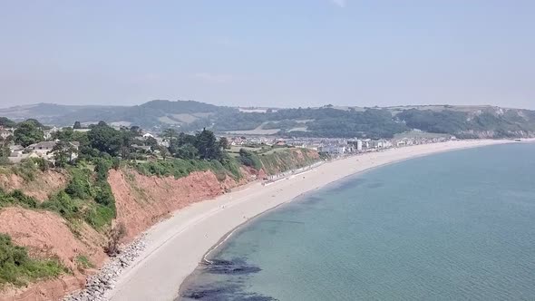 Flying parallel to the beautiful beach of Seaton in east Devon in England. The beach has white sand