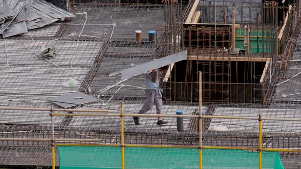 Construction Workers on the Rooftop of a Residential Building Under Construction