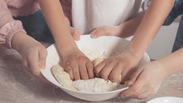 Close-up Slow Motion Children Mix Dough. Children's Hands and Dough.