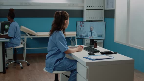 Nurse Talking to Doctor on Video Call for Professional Advice