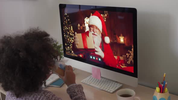 Happy African Kid Girl Talking To Virtual Santa on Video Conference Online Call