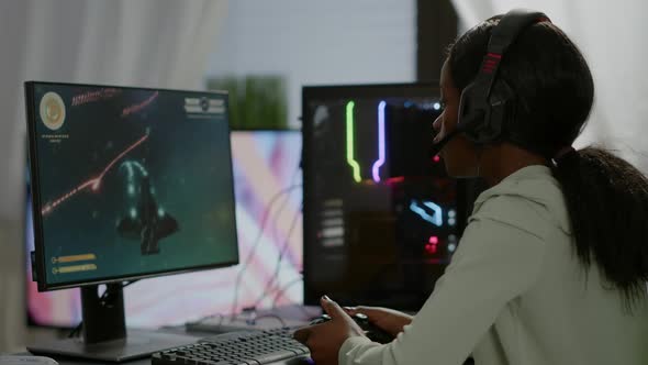 Pro African Gamer Playing Online Space Shooter Game on Powerful Computer