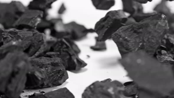 Super Slow Motion Shot of Coal Crashing on White Background at 1000 fps