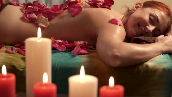 Satisfied Young Woman Relaxes After Massage in Spa Salon, Slider Shot