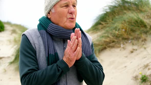 Senior man in sweater feeling cold