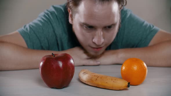 Sad Man Is Taking Out a Cake on the Table