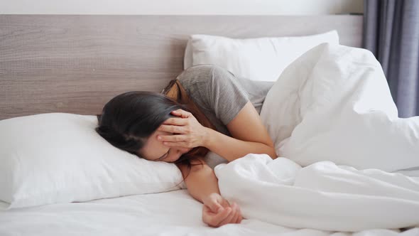 Lonely young woman feeling depressed and stressed sitting in the bedroom