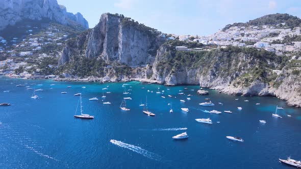 Aerial drone dolly shot of boats, yachts on the coastline of Capri,Italy.