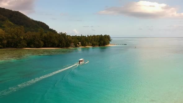 Aerial view of a boat cruise in the lagoon of Moorea, French Polynesia