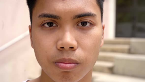 Close Up Shot of Asian Teenage Boy Looking at Serious Camera