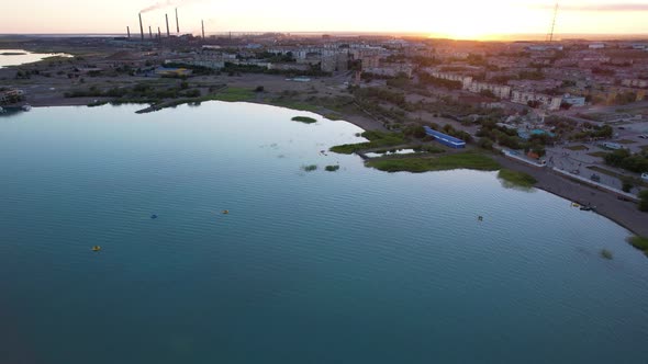 A Lake a Factory and a City at a Beautiful Sunset