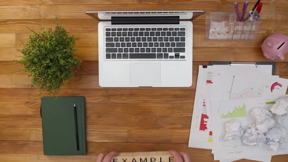 Term of Example From Wooden Cubes Made on the Table Next to a Laptop and Office Documents