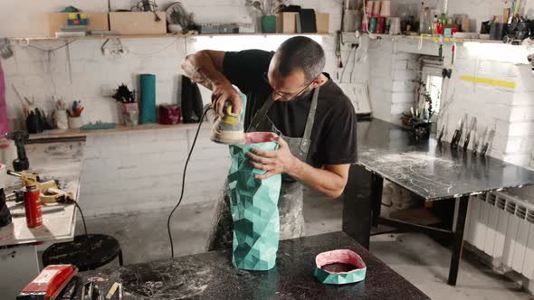 A male craftsman creates a decorative product with his own hands. Handmade, workshop. Creative