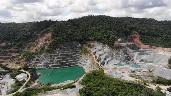 Aerial view of opencast mining quarry with big pool. Aerial view from drone shoot