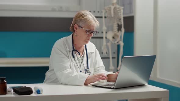 Portrait of General Practitioner Working on Laptop in Medical Office
