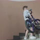 A Boy Lifting His Bicycle Up the Staircase - VideoHive Item for Sale