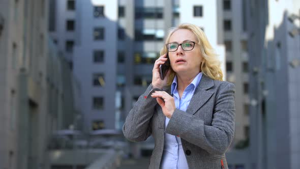 Senior Female Boss Feeling Angry and Disappointed Talking on Phone, Failure