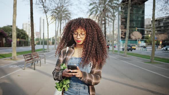 Attractive Mixed Race Girl Spending Time Outdoor Browsing on Social Networks