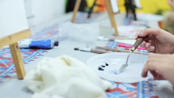 The artist learns to paint a picture with oil paints in an art studio.