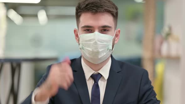 Young Businessman with Protective Face Mask Showing Thumbs Up