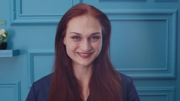 Portrait of Woman in Medical Uniform Smiling Winking Flirting a Bit