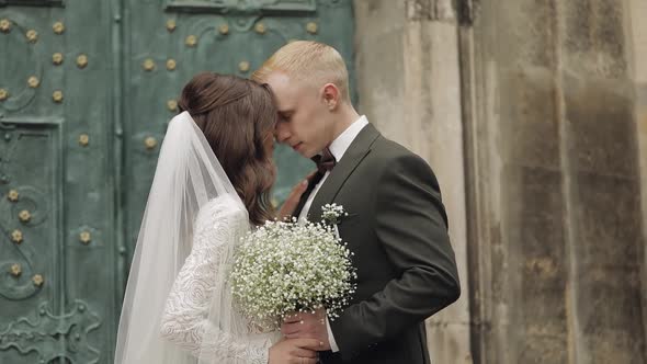 Newlyweds Caucasian Groom with Bride Walking Embracing Hugs in City Wedding Couple in Love