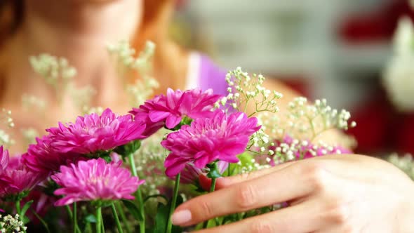 Female florist arraigning flower bouquet